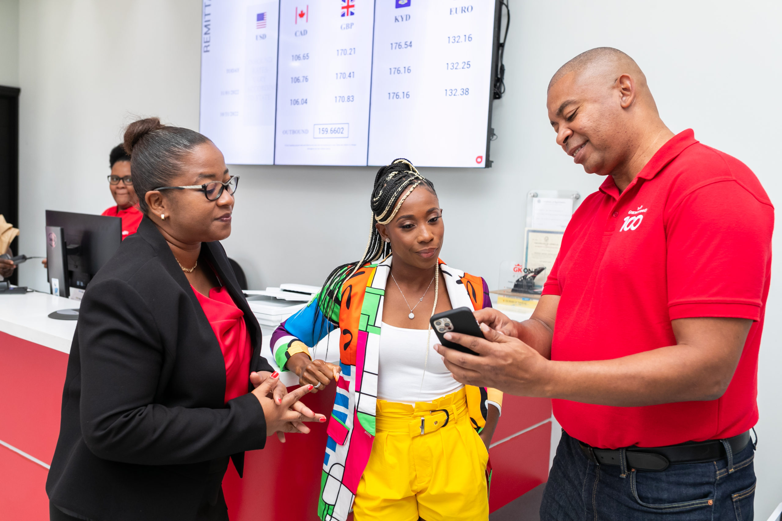 GK ONE App DEMO: GraceKennedy Brand Ambassador and face of the GK ONE pre-paid Visa Debit Card, Olympian, and World Champion Shelly-Ann Fraser – Pryce getting a personal tutorial on how to use the App from Rickard Ebanks, GraceKennedy Chief Digital Officer while Annalise Harewood, Regional Manager, Digital Operations, GraceKennedy Money Services looks on. Over 290 million Jamaican dollars in Western Union remittances have been received in the app with GK ONE saying that 69% of customers are repeat users.
